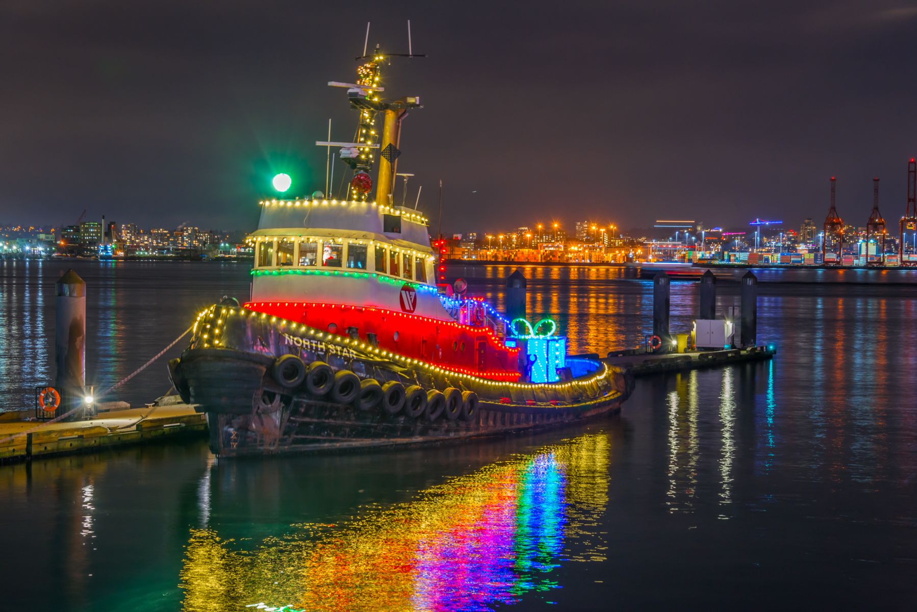Tug boat decorated in Christmas lights