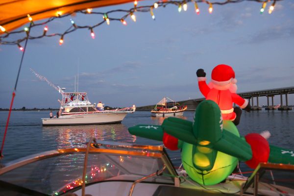 Santa inflatable waving at boats in boat parade
